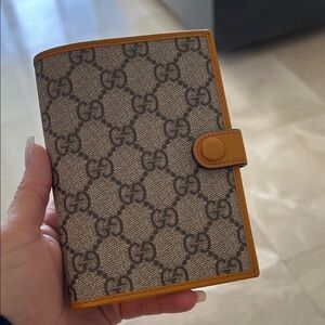 Gucci Beige Monogram Wallet with Mustard Trim
Passport holder